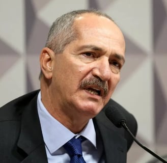 a man in a suit and tie is speaking into a microphone