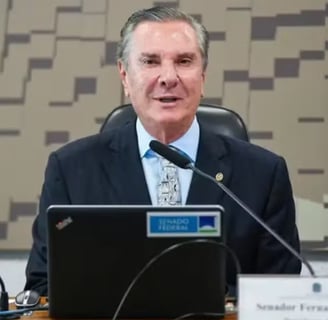 a man in a suit and tie is sitting at a desk