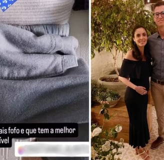 a man and woman standing in front of a heart shaped object