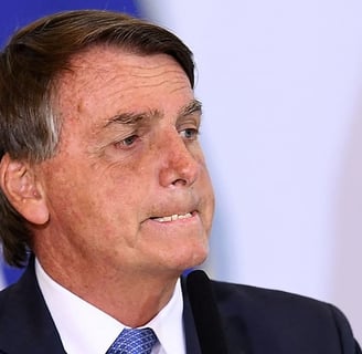 a man in a suit and tie is looking at something