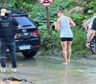 a group of police officers standing in front of a car