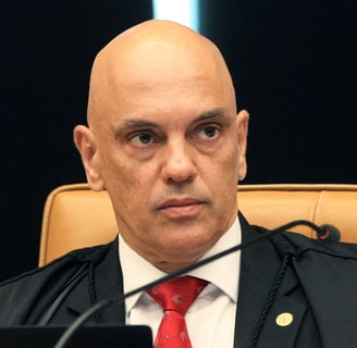 a man in a suit and tie is sitting in a chair