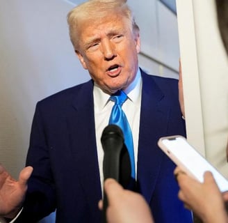 a man in a suit and tie is talking to a reporter