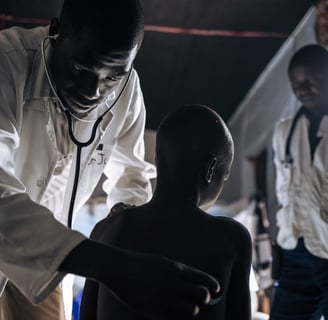 a doctor examining a child's chest with a stethoscope