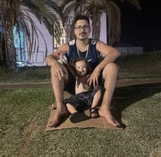 a man sitting on a mat with a child