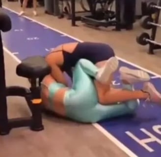 a woman is doing a backflip in a gym