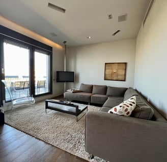 a living room with a couch and a television in thessaloniki