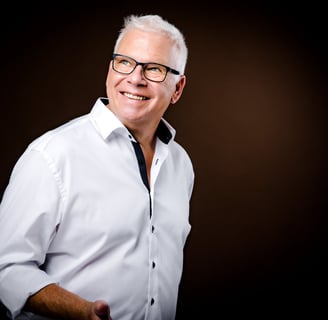 Martin in a white shirt and black tie dye