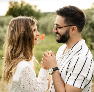 Provence engagement photographer — couple smiling, holding a poppy flower