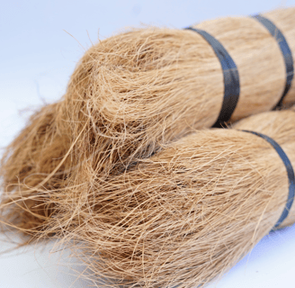 a couple of brooms sitting on top of a pile of hay