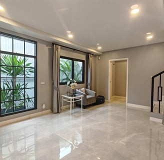a living room with a couch and a staircase