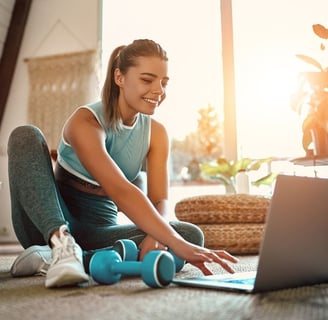 a woman sitting having a virtual physio session with the london physio