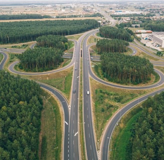 a highway intersection with a road and trees