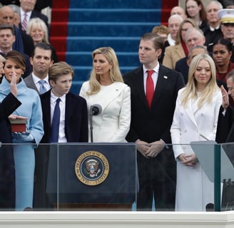 a group of people standing around a podium with a president obama