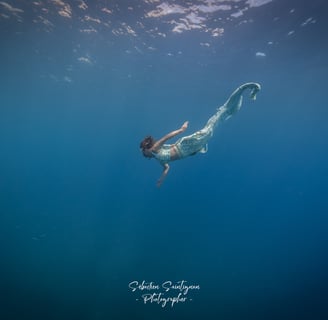 Mermaid swimming peacefully in the sea. Photo taken by Sébastien Saintignan