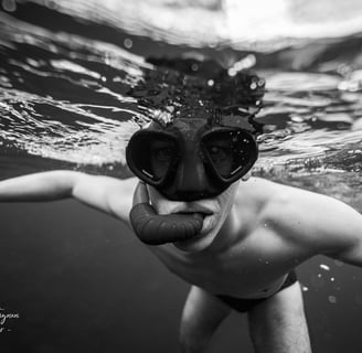 a model in a swimsuit with a mask on his face. Photo taken by Sébastien Saintignan