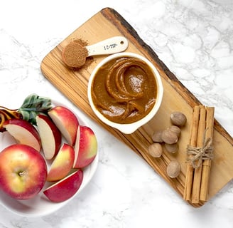 Apples with caramel on cutting board