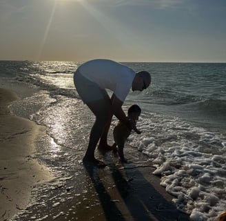 a man and his baby playing in the water