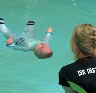 a woman in a wetsuit is swimming in a pool