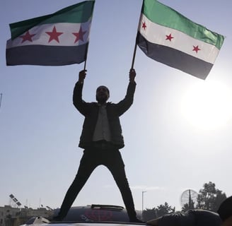 Man holding flags of Syrian Opposition Group