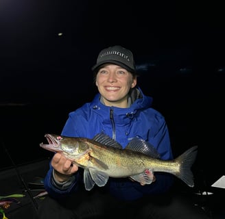 Female angler displays her night-caught zander.