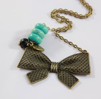 a necklace with a bow tie and a necklace with a bow