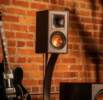 a guitar and a speaker system in a room