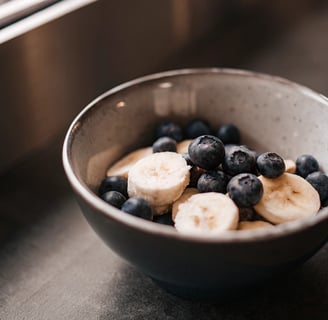 Fresh blueberries and banana slices served for a cat.
