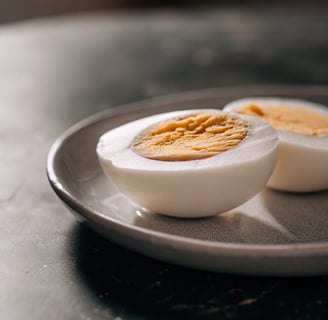 A hard-boiled egg sliced and ready to be served to a cat.