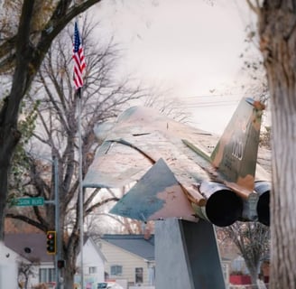 Jet display in Mountain Home Idaho with an American flag.