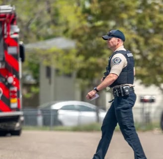 Ada County Sheriff Deputy crossing the street behind a fire truck in Idaho.