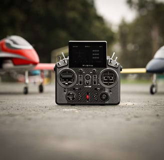 FrSky X20 Pro Transmitter being flanked by 1 red RC Jet and 1 grey RC Jet