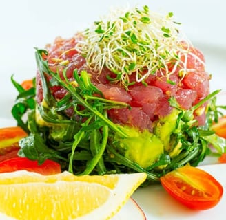 a tuna salad with a lemon wedged in the center