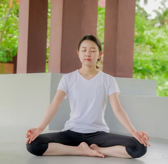 a woman sitting in a yoga pose