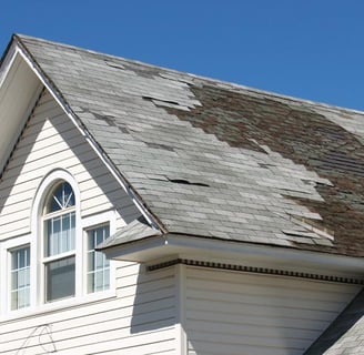 a house with a large white house with a brown roof