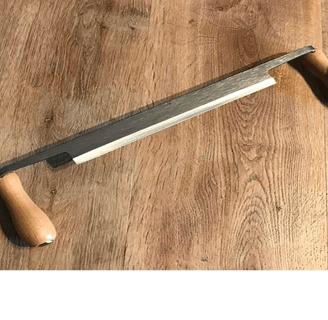 a draw knife on a wooden table