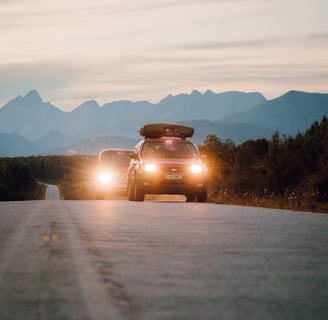 Campers travelling with lights on in the evening