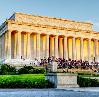 a large building with a lot of people walking up the stairs