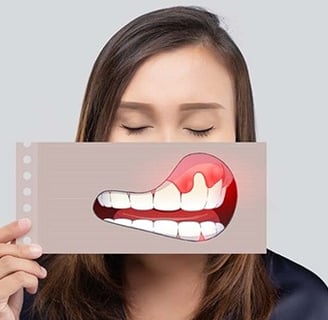 a woman holding a card with a painful smile