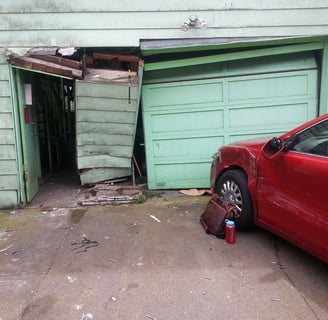 Fix garage door crashed into by car.