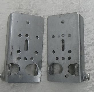 Bottom fixtures for garage door cables.