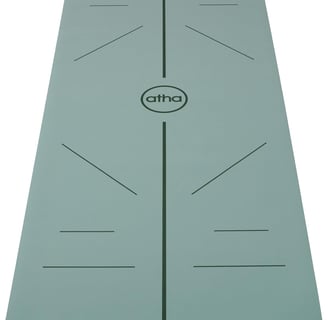 a yoga mat with a green mat and a white background