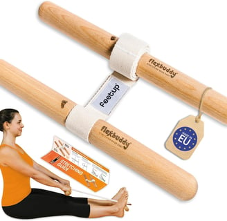 a woman sitting on a yoga mat with a yoga mat and holding an a flexbuddy