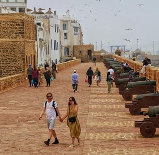 morocco a couple holding hands while walking down a path