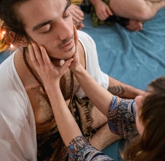 a man with a beard and a woman in a white shirt
