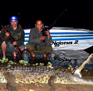 two men are holding guns and a gun in the water