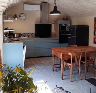 a kitchen with a table and chairs and a clock