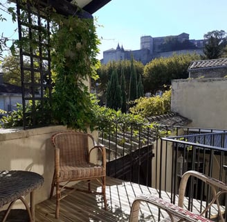 a balcony with a chair and a table