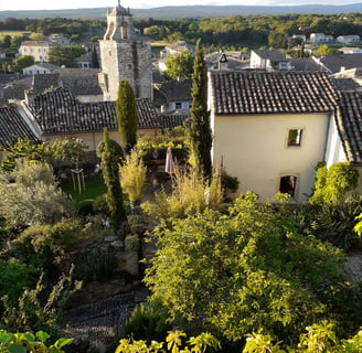 a view of a church with a clock tower in the background