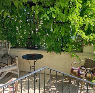 a patio with a table and chairs and a table